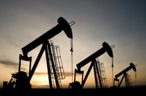 Oil prices dip on record U.S. output, but global market tense