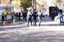 Police officers apprehend people gathering in Liberty Square