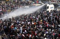 Myanmar coup: Police use water cannon as thousands strike