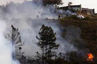 Wildfire in California destroys 15 homes, forces 100 to flee