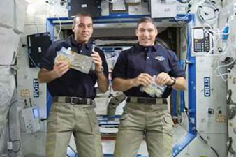 Two American astronauts get ready for orbiting lab repairs