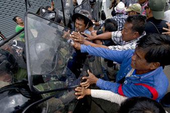 Thai anti-government protesters gather outside defense compound