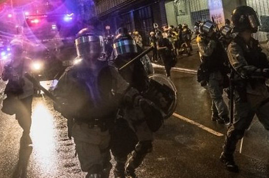 Hong Kong police fire gun and use water cannon on protesters