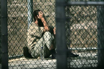 Obama, in blow to closing Guantanamo, signs law